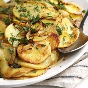 Lyonnaise Potatoes served on a white oval platter