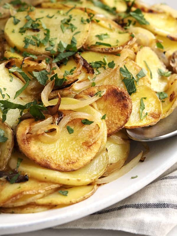 Lyonnaise Potatoes served on a white oval platter