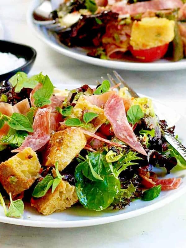 Muffuletta Panzanella Bread Salad served on white plates featured