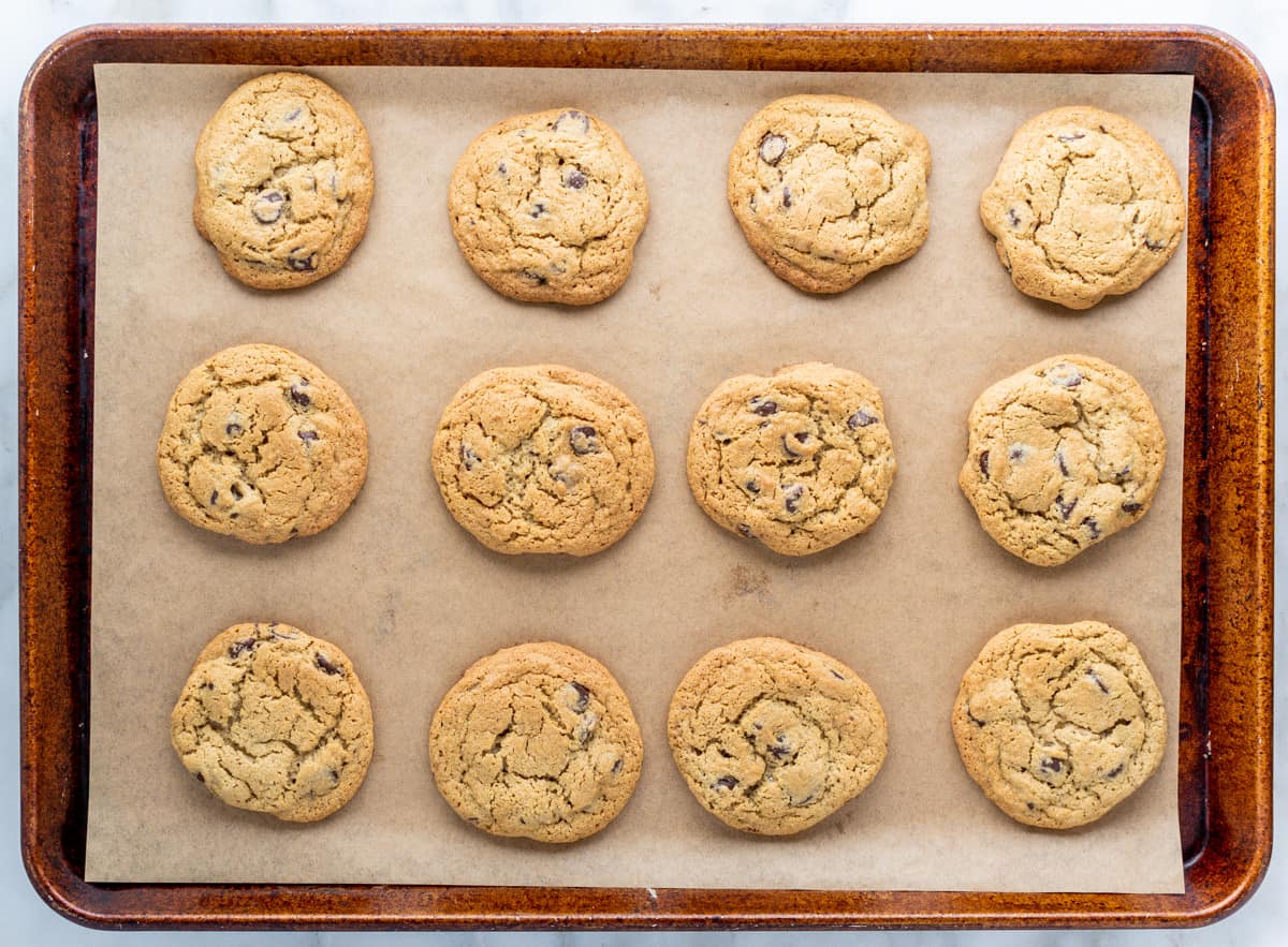 Oat Flour Chocolate Chip Cookies on a parchment lined baking sheet.