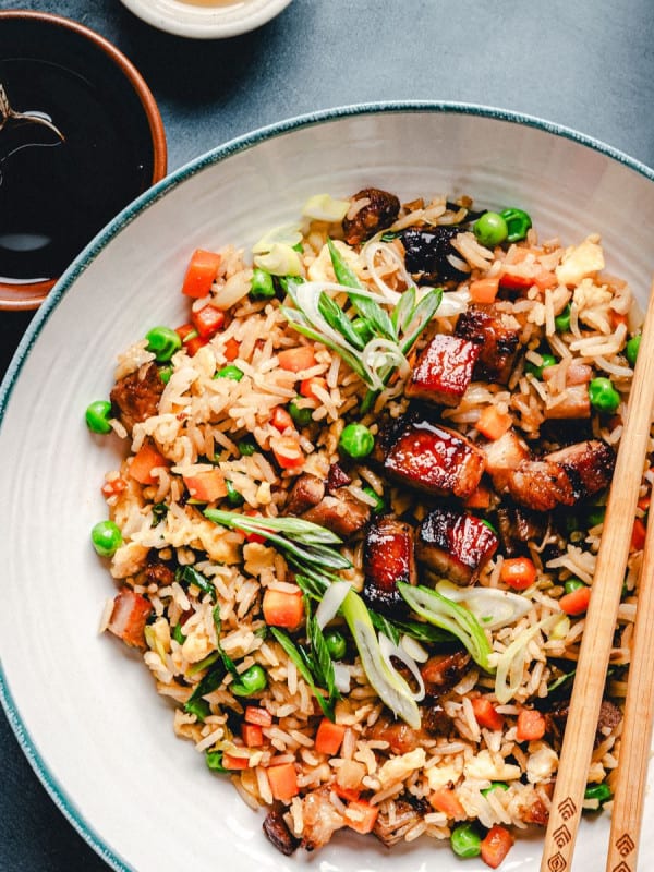 Pork Belly Fried Rice served in a white bowl and photographed from the top.