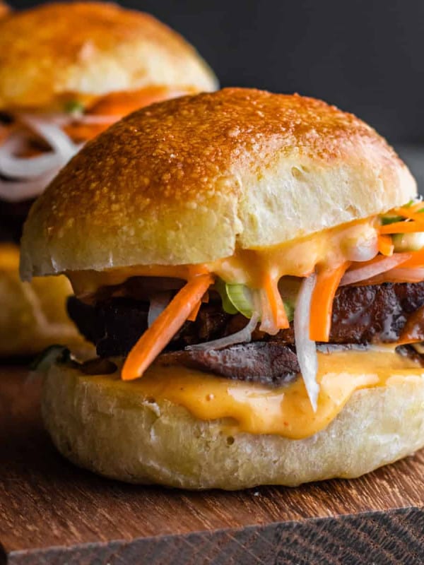 Pork Belly Sliders on a wooden serving board