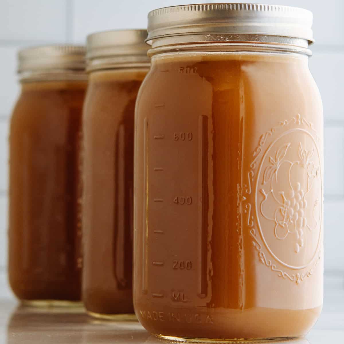 Homemade Pork Bone Broth in glass quart canning jars.