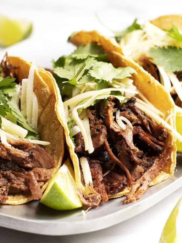 Pork Carnitas Tacos served on a metal platter