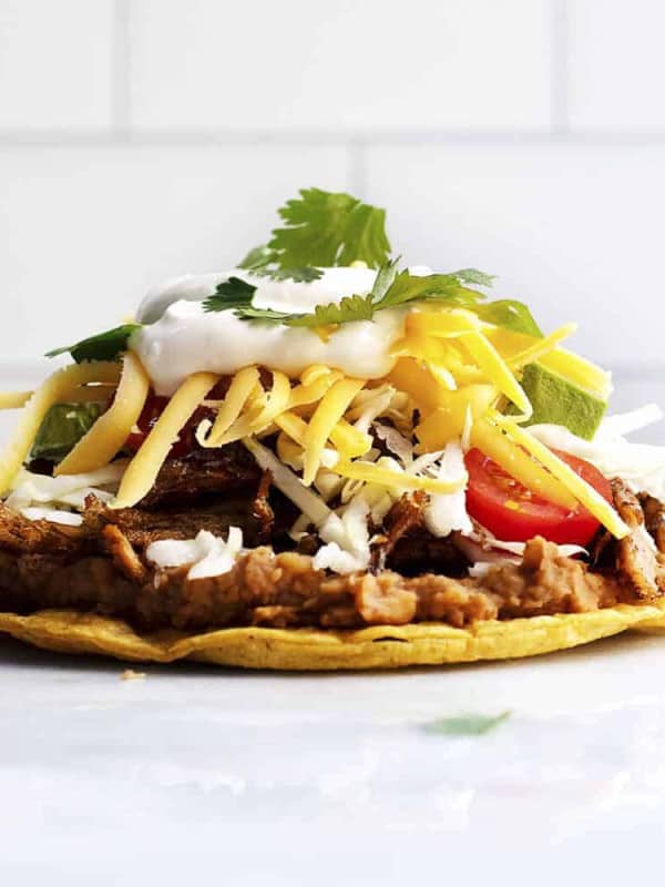 Pork Carnitas Tostada on a marble slab