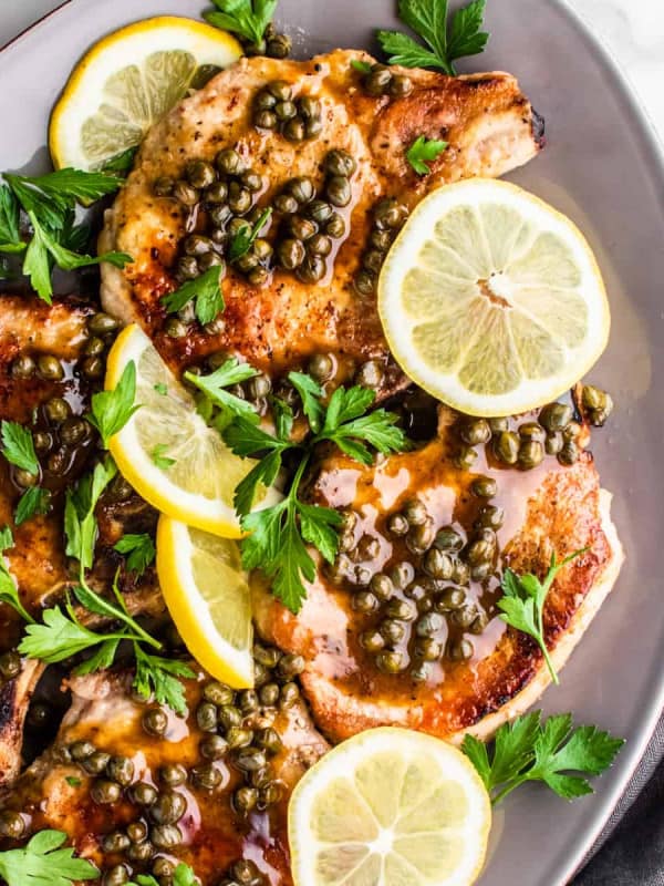 Pork Piccata served on a gray oval platter.