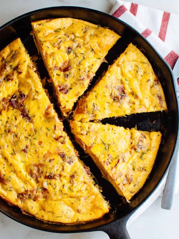 potato frittata sliced into wedges in a cast iron skillet photographed from above.