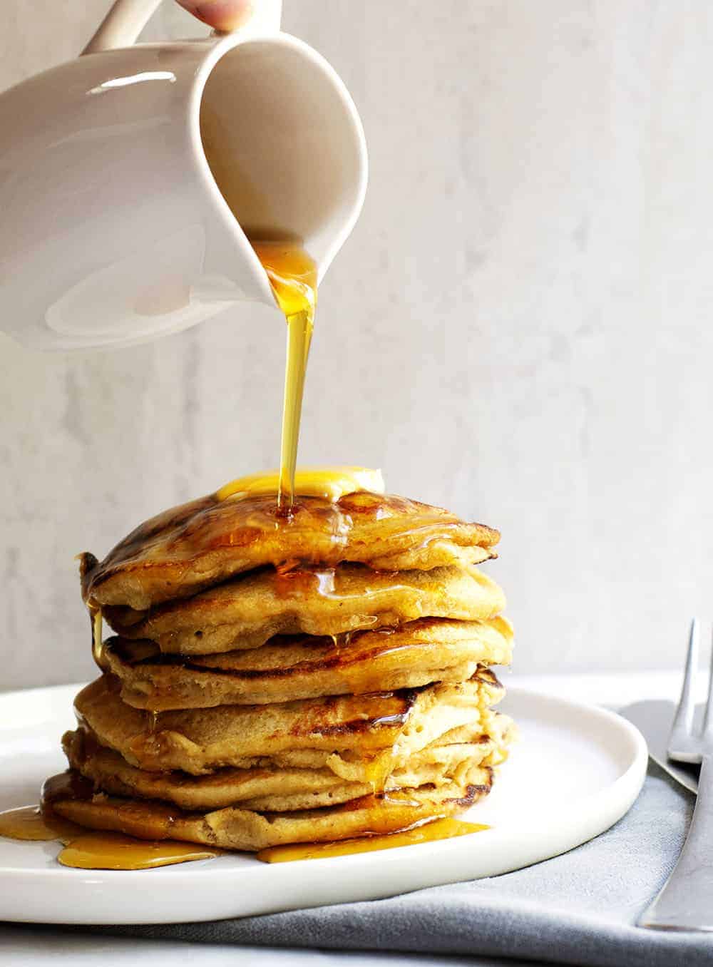 Pouring Syrup over Banana Oatmeal Pancakes