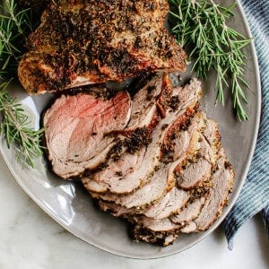 Roasted Boneless Leg of Lamb served on a gray oval platter.