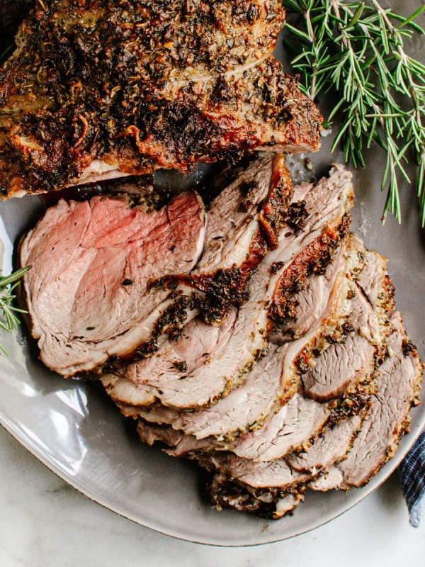 Roasted Boneless Leg of Lamb served on a gray oval platter.