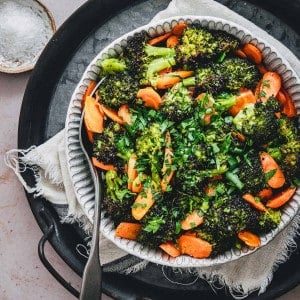 Roasted Broccoli and Carrots served in a white ceramic bowl and photographed from the top.