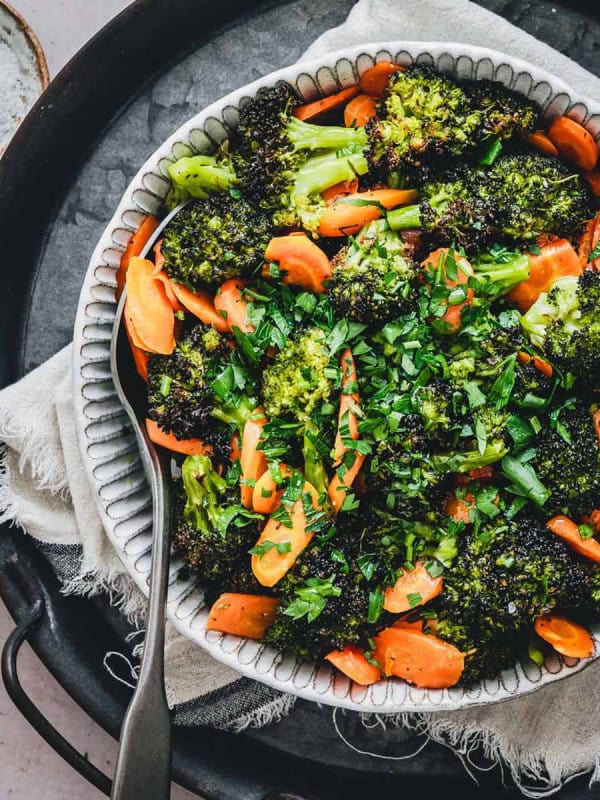 Roasted Broccoli and Carrots served in a white ceramic bowl and photographed from the top.