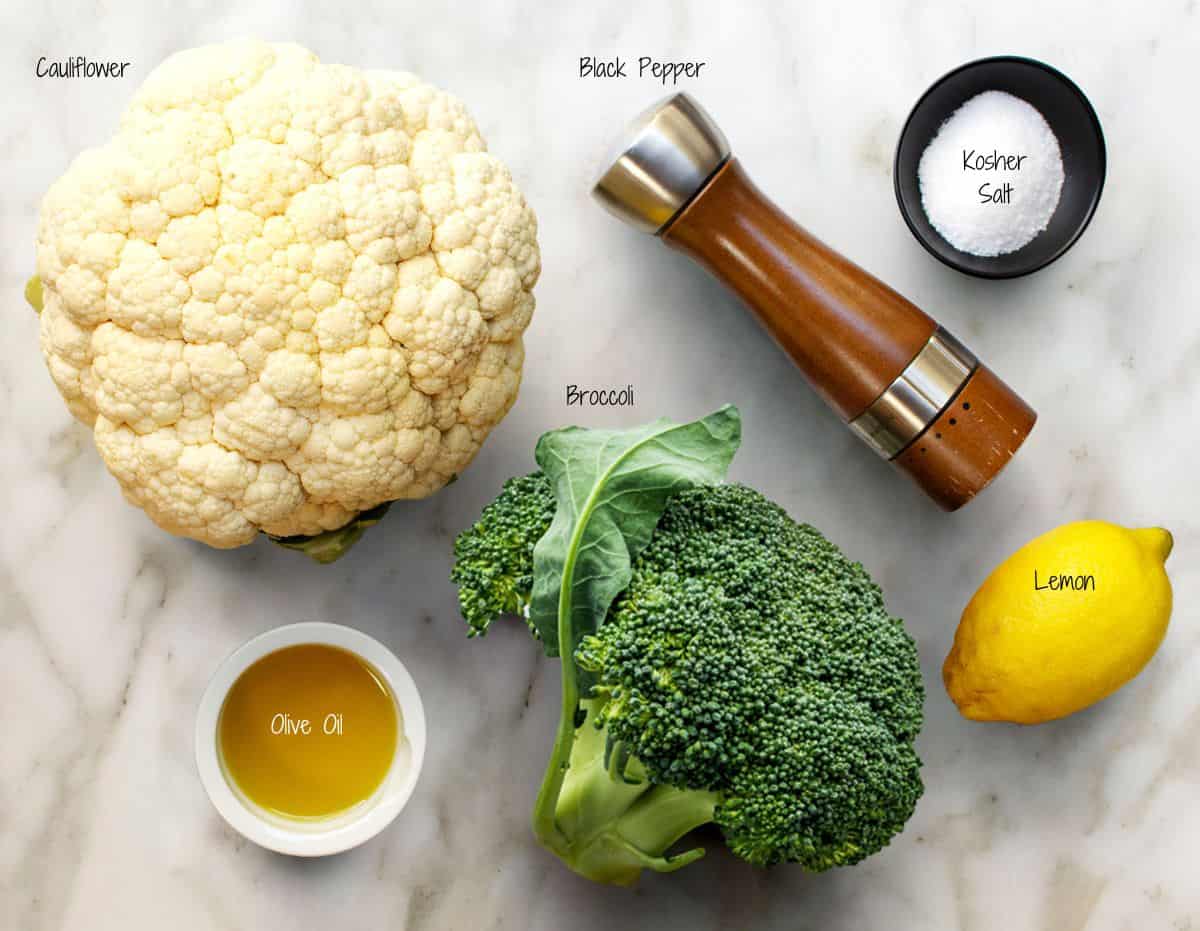 Roasted Broccoli and Cauliflower Ingredients on a white marble board.