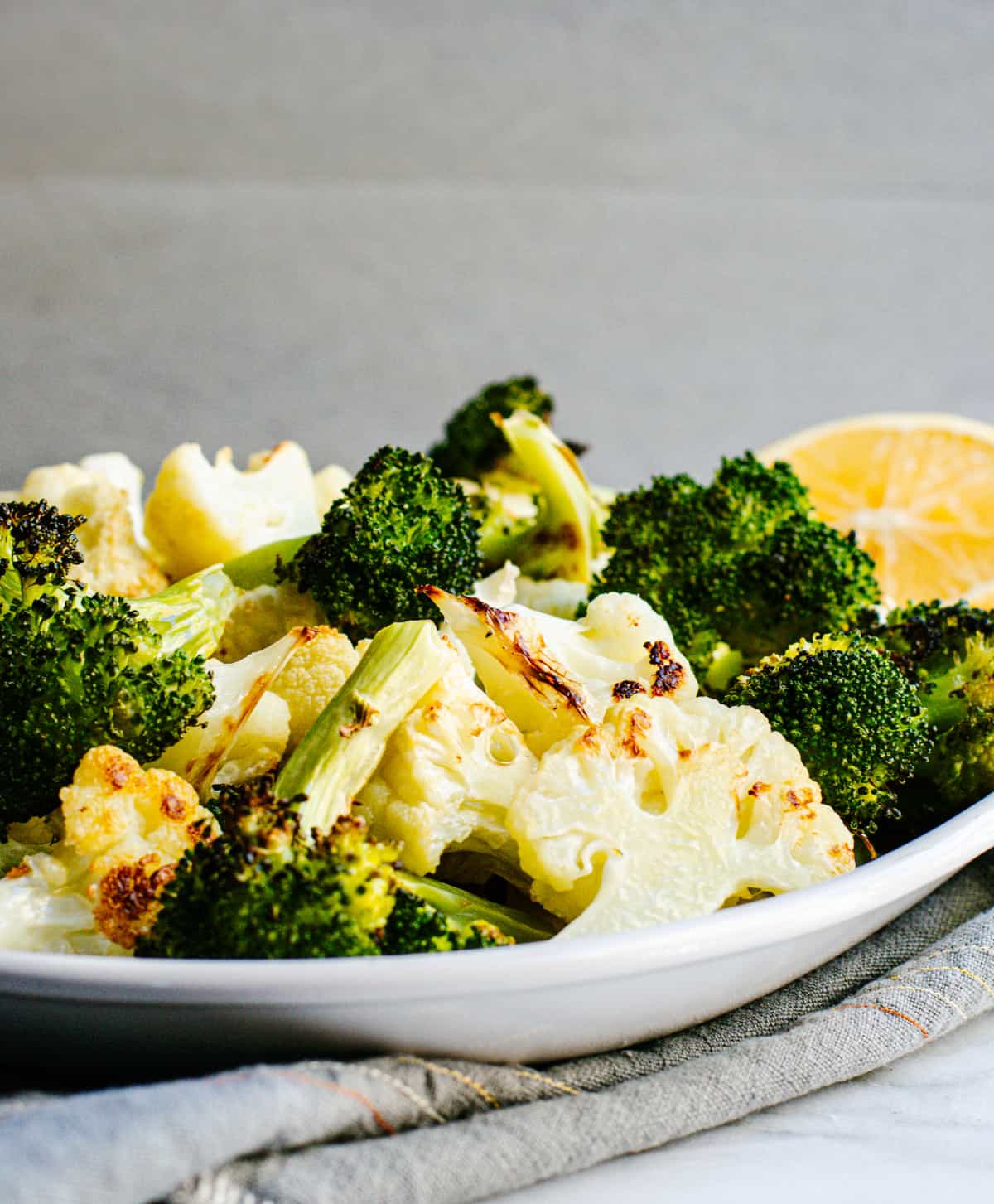 Roasted Broccoli and Cauliflower on a white ceramic platter.