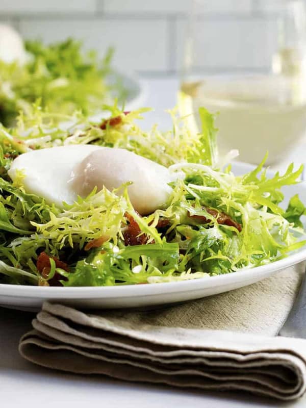 Salad Lyonnaise served on a white plate