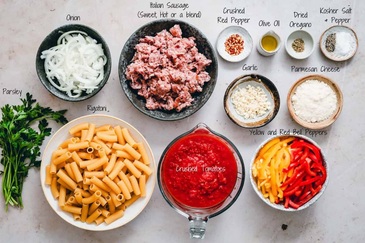 Sausage and Peppers Pasta Ingredients on a granite surface.