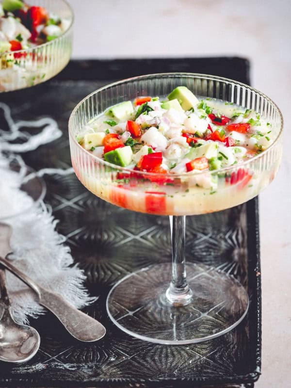 Scallop Ceviche served in coupe glasses on a metal tray.