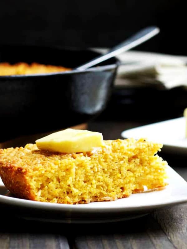 Skillet-Cornbread-served-with-butter on a white plate