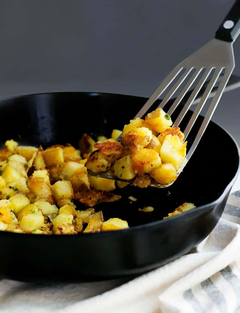 Skillet_Potatoes_on spatula in_a_Cast_Iron_Skillet