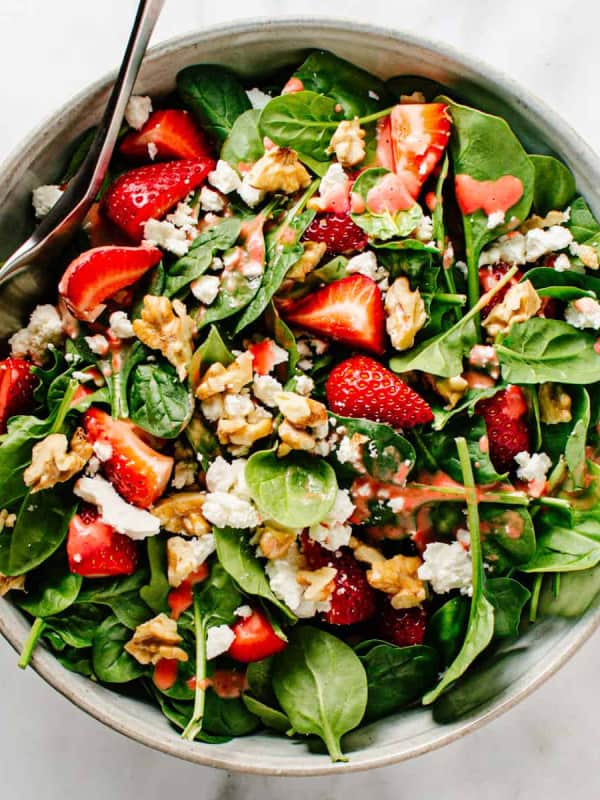 Spinach Strawberry Walnut Salad served in a light gray ceramic bowl