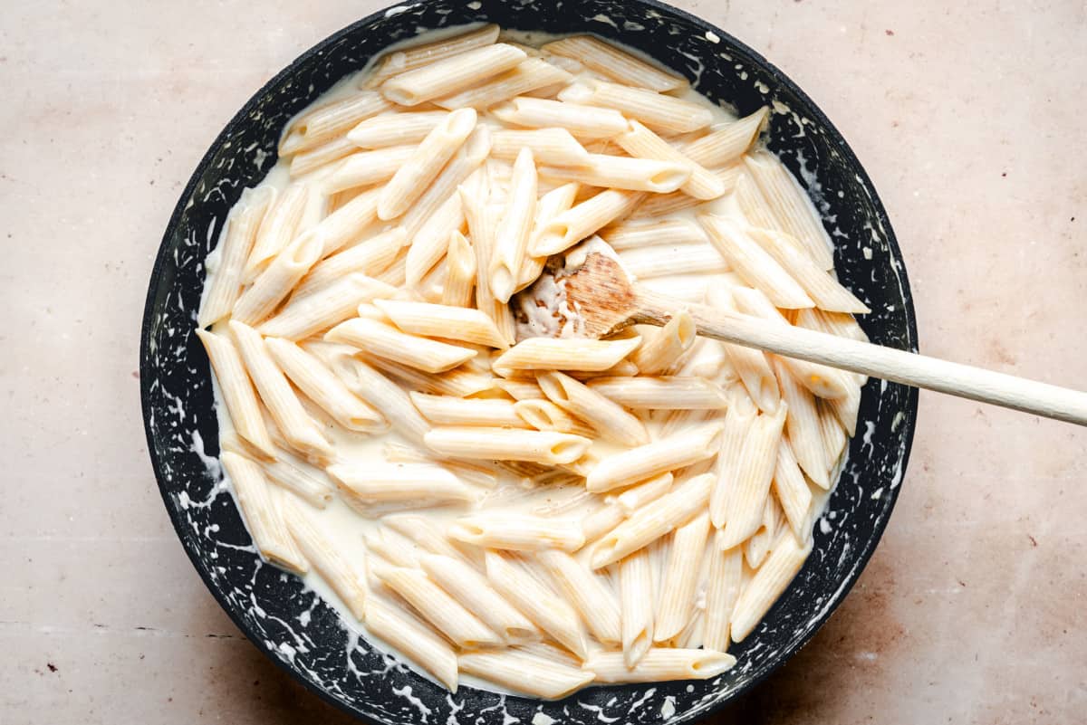 creamy pasta in skillet ready to serve.