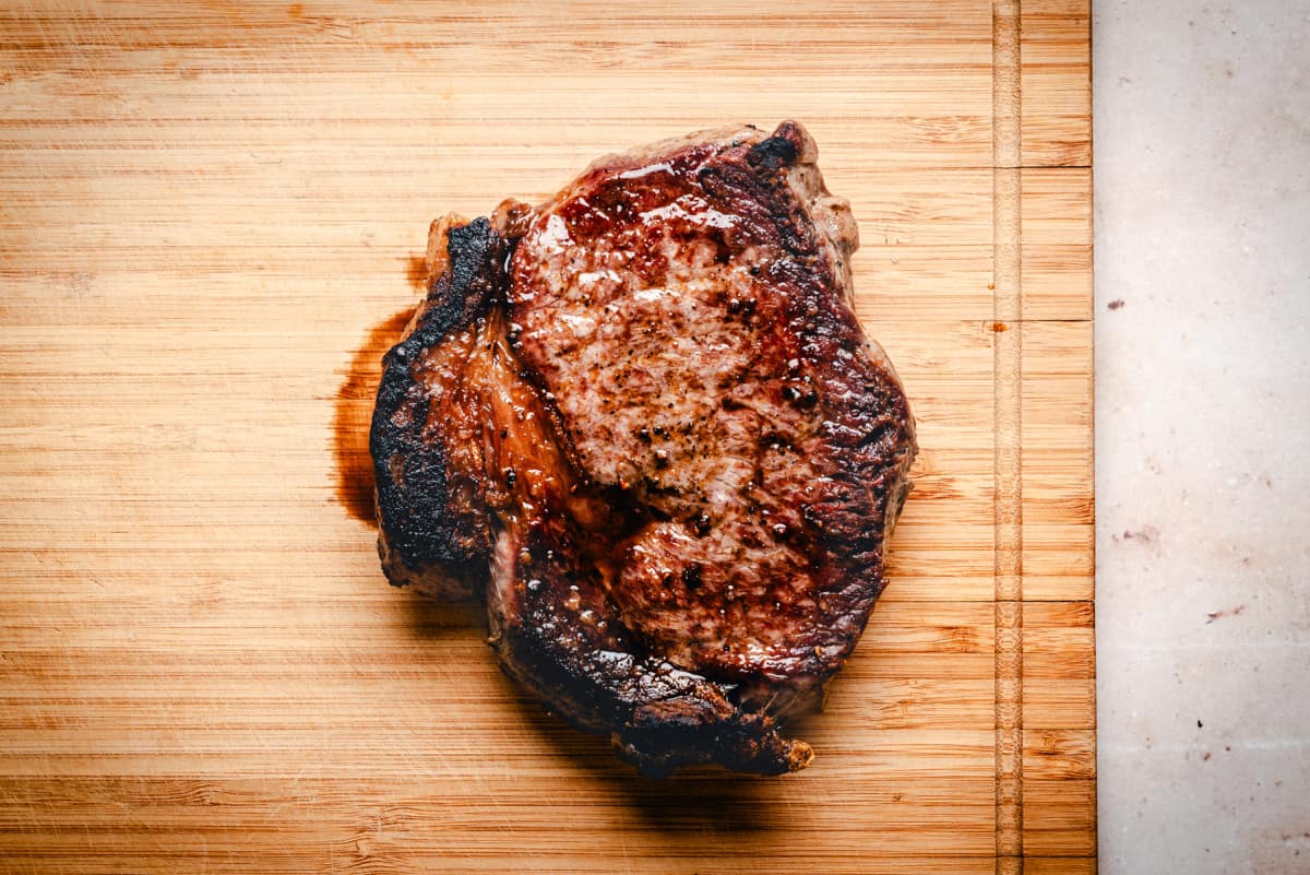 seared steak on cutting board.