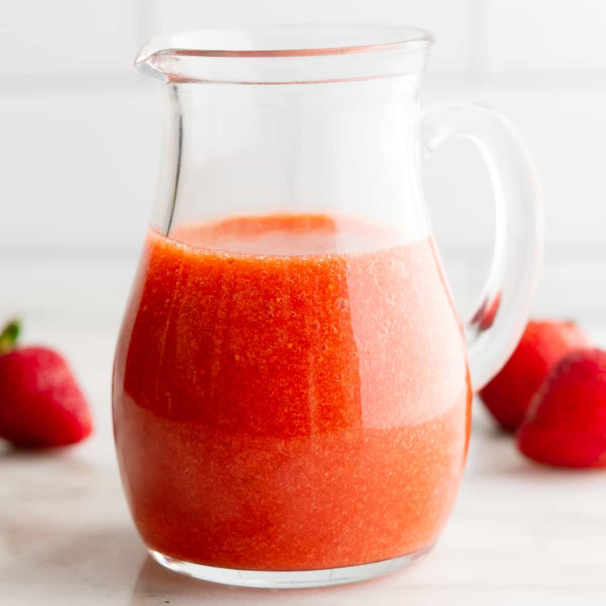 Strawberry Vinaigrette in a clear glass pitcher