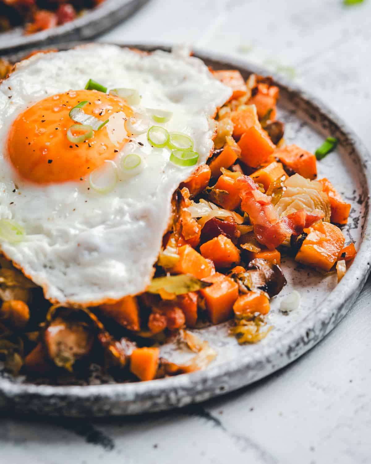 Close up of single plate of Sweet Potato Hash from angle.