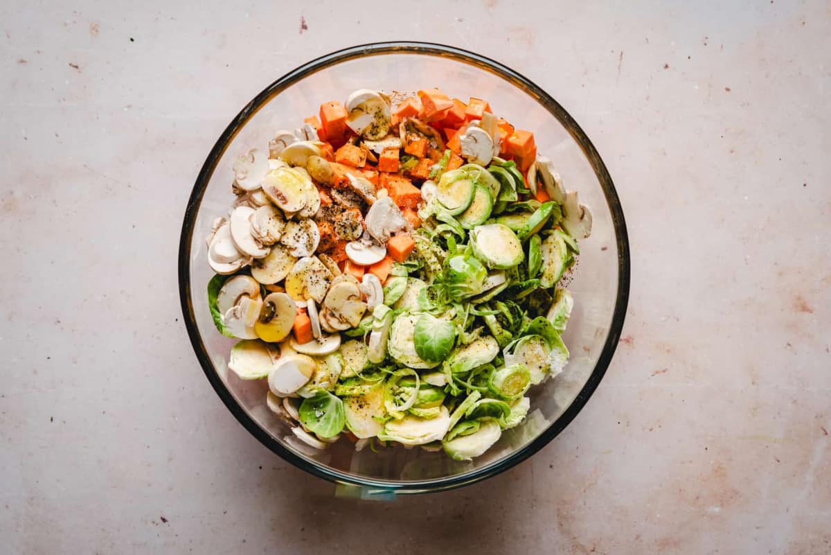 Sweet Potato Hash vegetables and seasoning in glass bowl.