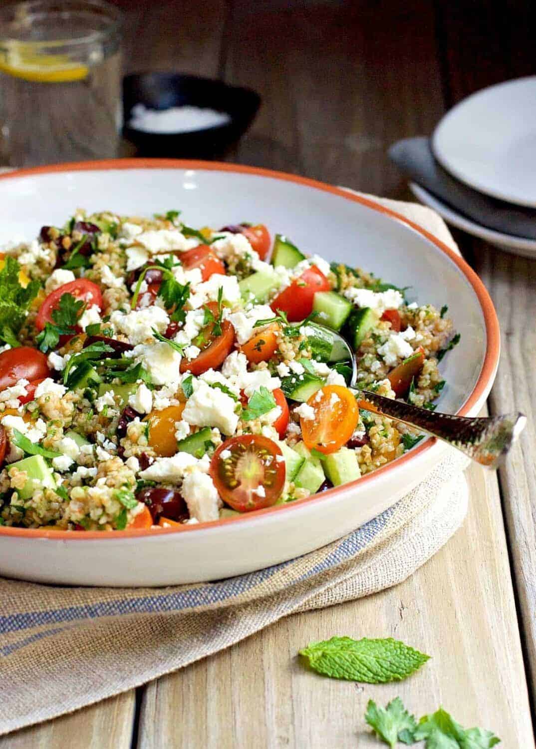 Tabouli salad is a classic Levantine dish (also spelled tabbouleh and tabouleh), a vegetarian salad that is loaded with flavor and texture. From crisp cucumber, sweet tomatoes, briny olives and bright parsley, every bite is a little different. Bulgur wheat makes the salad hearty enough to make it a main dish and I love to add salty creamy feta to make the salad even better.