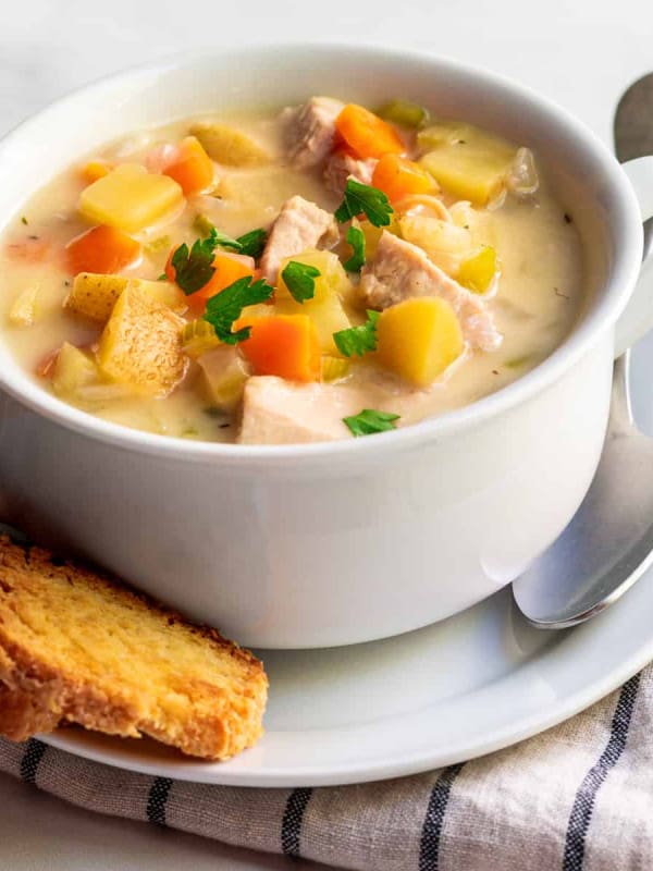 Turkey Pot Pie Soup served in a white bowl