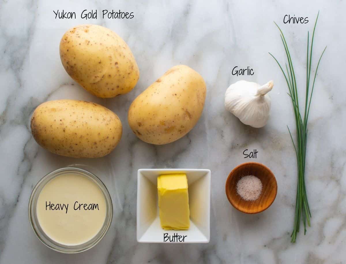 Yukon Gold Potatoes Ingredients on a white marble board.