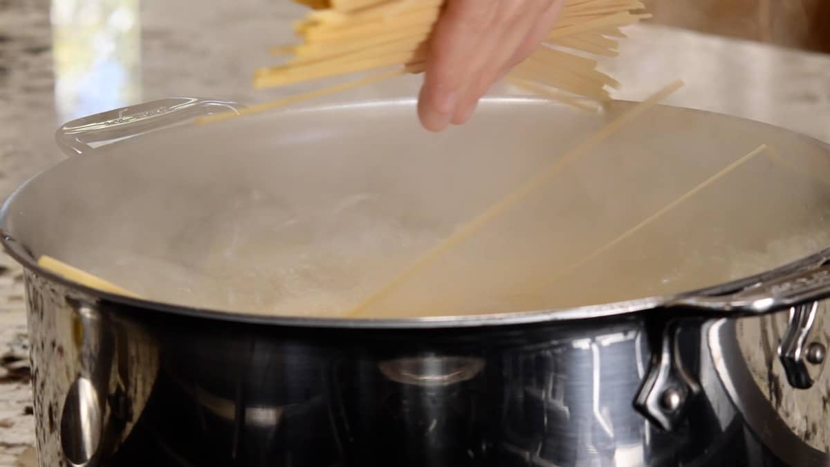 adding pasta to boiling water.