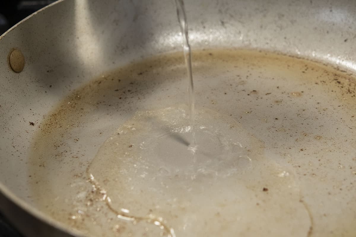 adding water to skillet