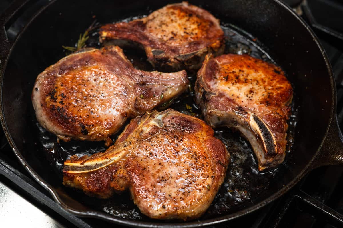 cast iron pork chops ready to serve.