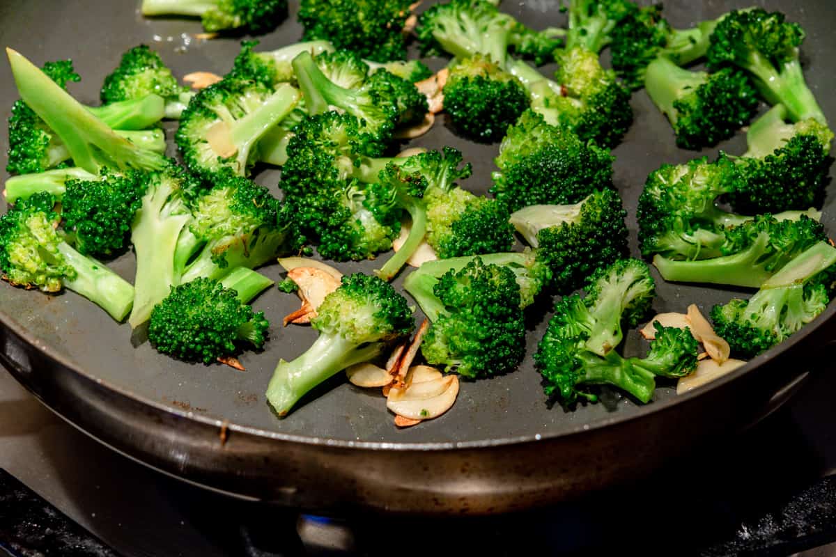 cooked broccoli and garlic in skillet.