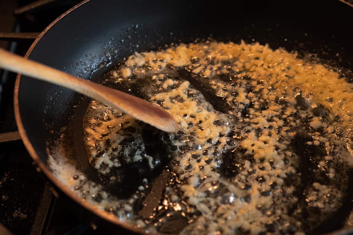 cooking garlic in butter in a skillet.