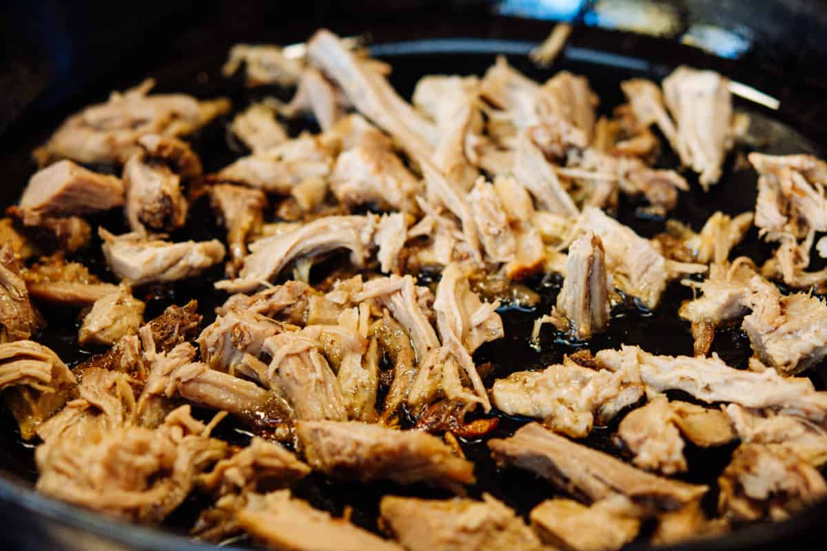 leftover pulled pork in a cast iron skillet