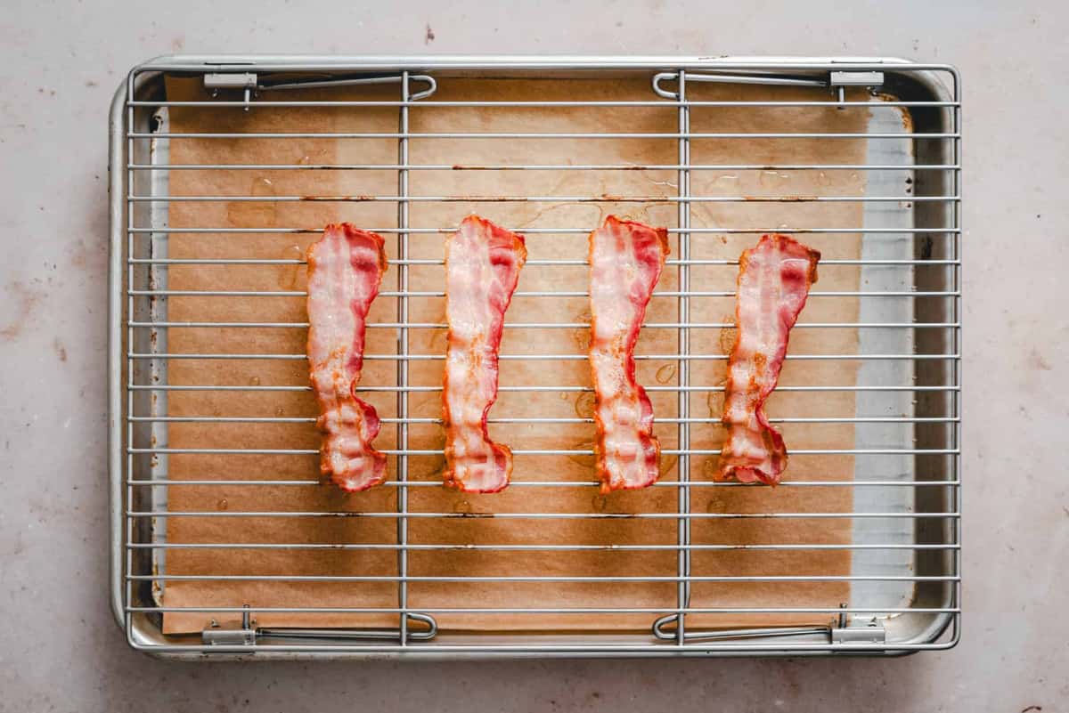 partially cooked bacon on rack.