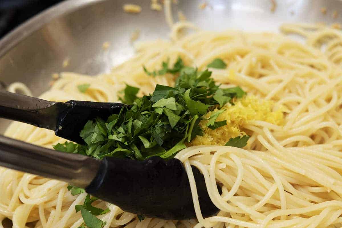 tossing pasta with parsley lemon juice and zest