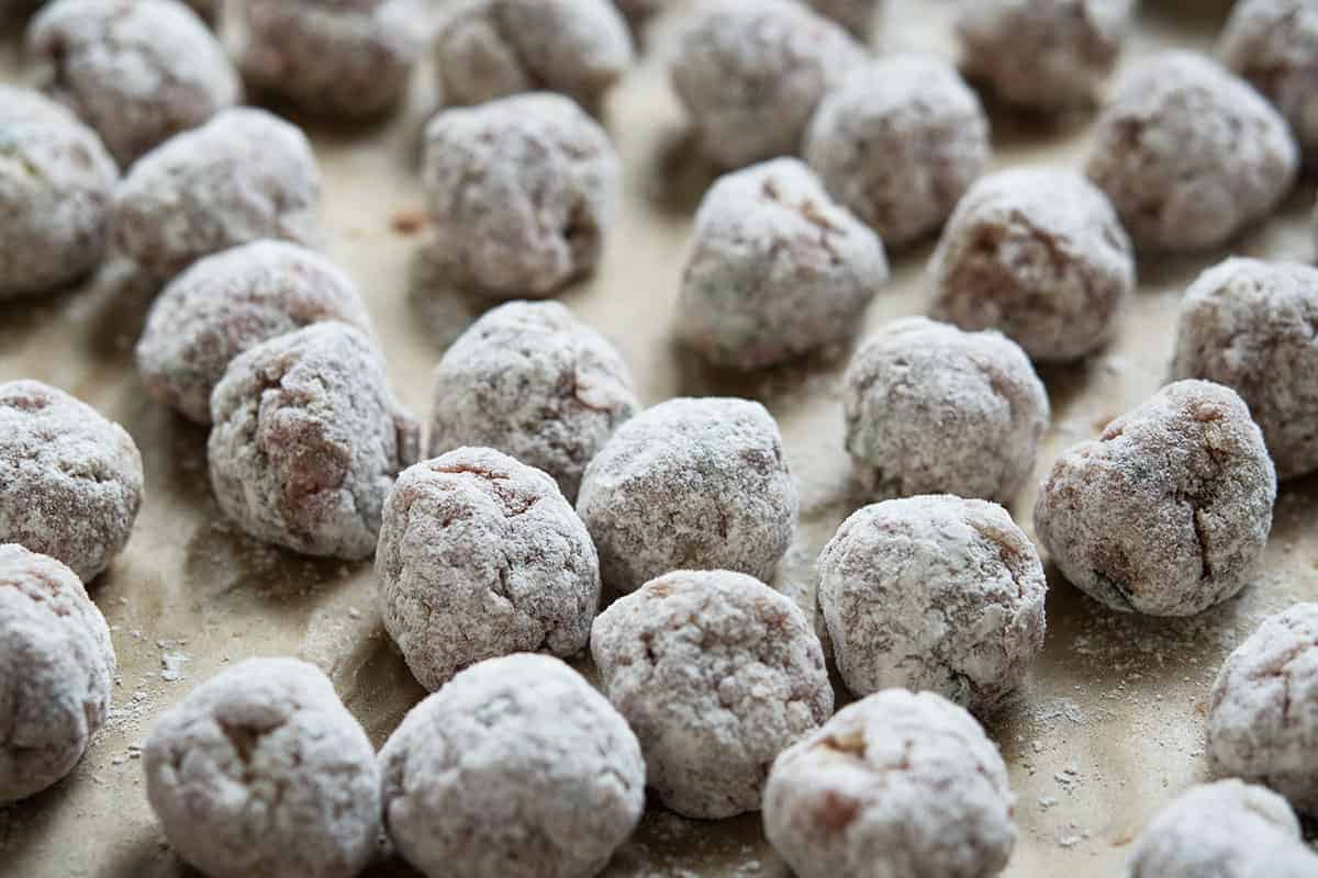 raw meatballs lightly coated in flour