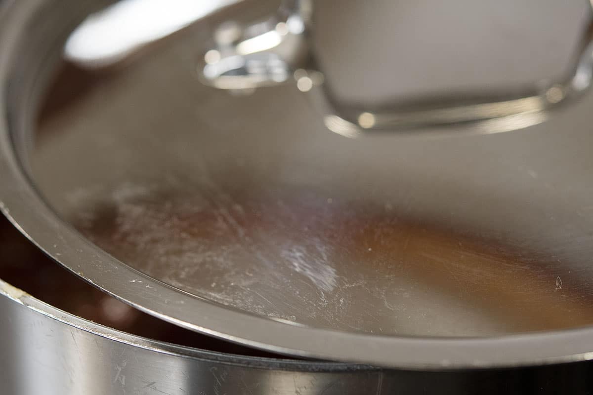 sauce simmering in partially covered pan