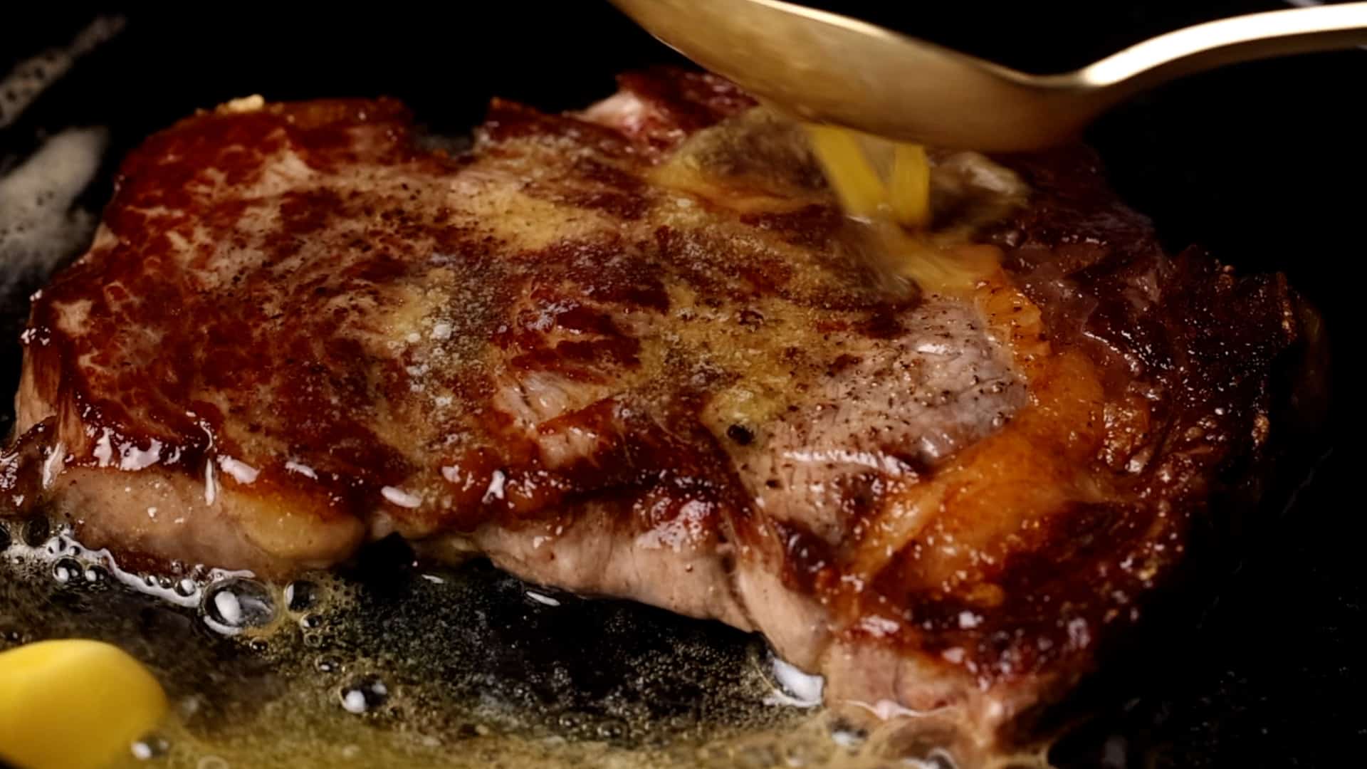 showing how to butter baste a steak