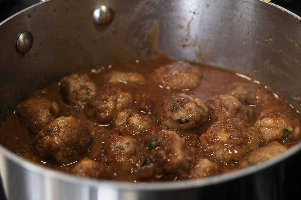 spanish meatballs in sauce in saucepan