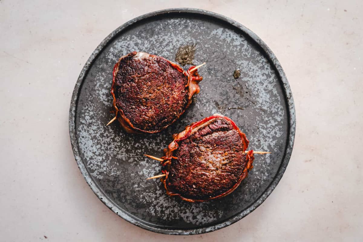 filet mignon steaks resting on a plate just before serving