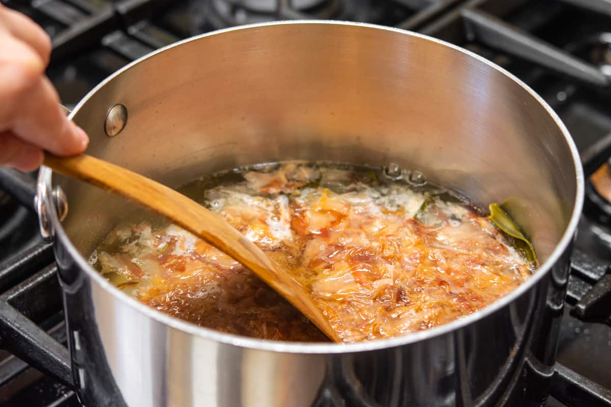 stirring bonito flakes into hot water with kombu.