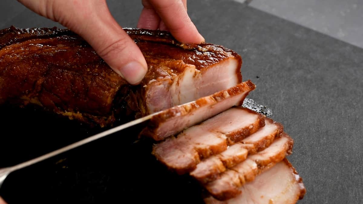 thinly slicing chashu pork