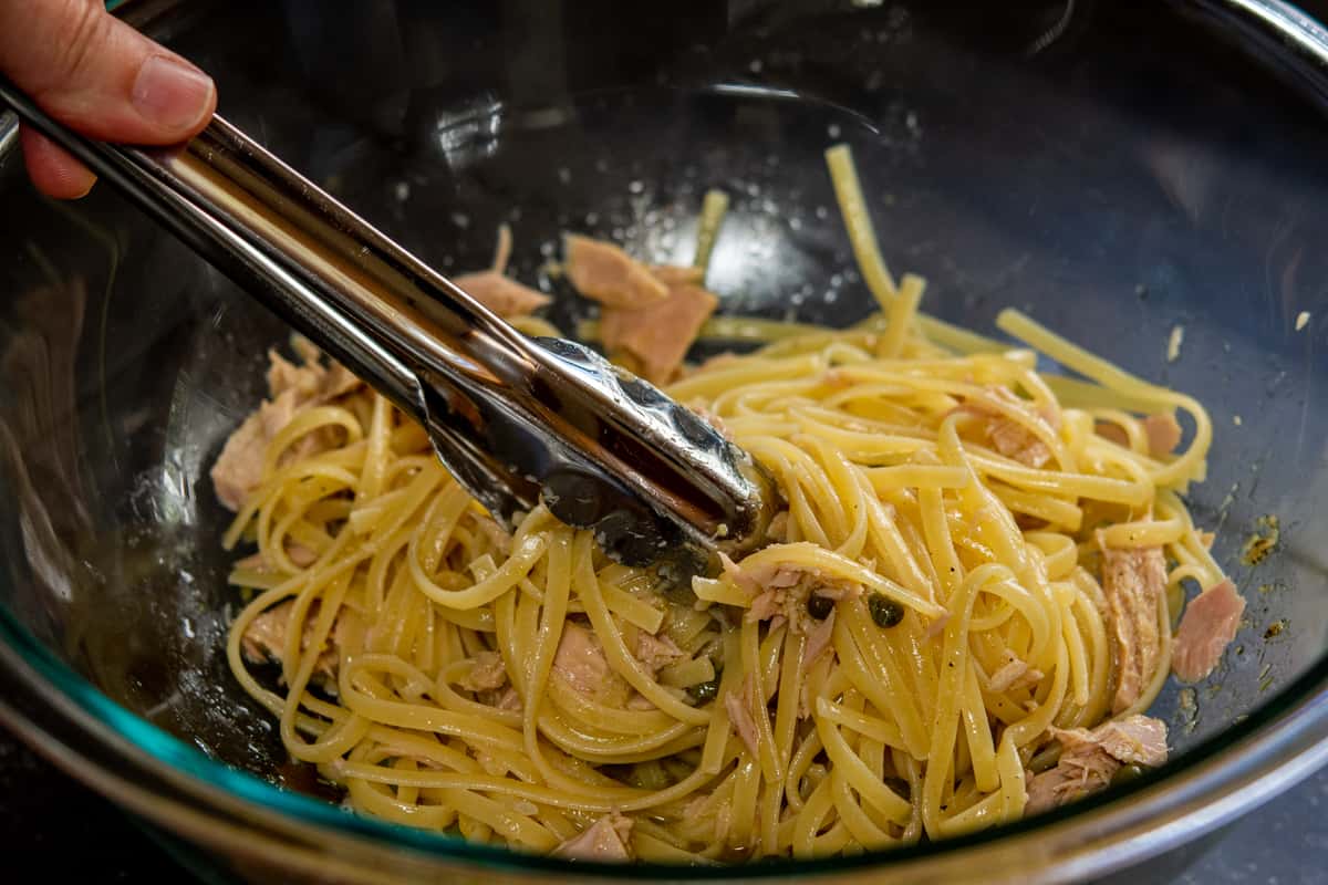 tossing hot pasta with warmed tuna mixture.