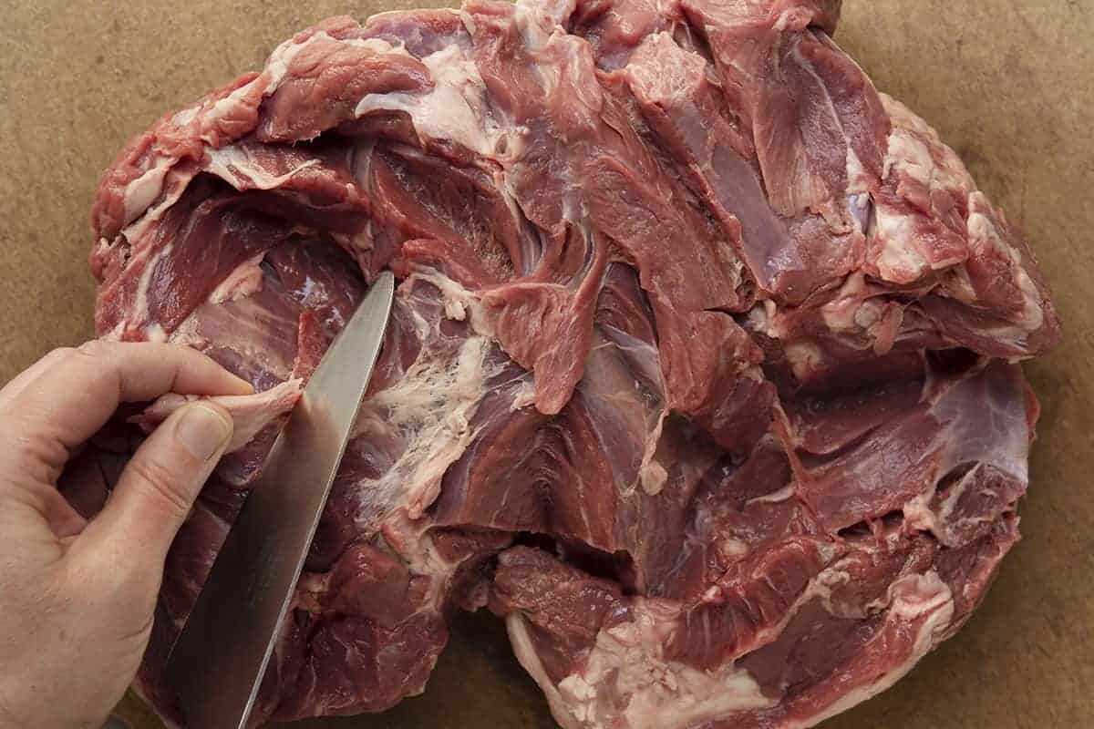 trimming fat from boneless leg of lamb